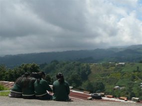 Local school children sit overlooking the val