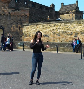 A girl posing in the walkway to the castle