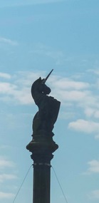 A unicorn atop a building