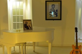 John's room with piano and guitar