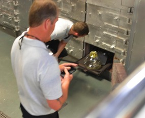 Placing the shaped glass into the cooling kiln