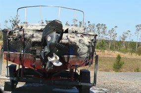 Burnt boat on Tin Can Bay road