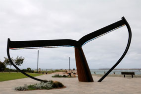 Whale tail sculpture on foreshore 
