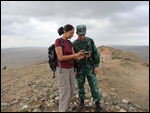 Azerbaijani border guard viewing photos from Sheki