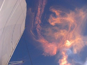 Shuttle Discovery Contrails in Rising Sun