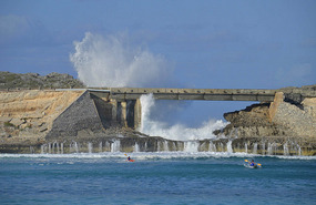 Kayakers surf the waves at the Glass Window