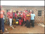 With the team and homeowner in front of completed 