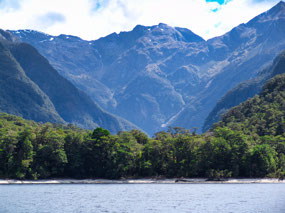 lake surrounded by snow-dusted mountains