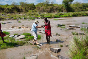 Mrufa helping Lois stay on Rocks