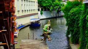 Čertovka Canal - cute statue by Waterwheel