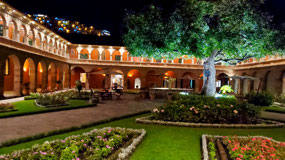Courtyard at night, view of lights up mountain