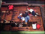 People waiting to be rescued from their roof.
