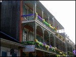 Iron railings with Mardi Gras decorations.
