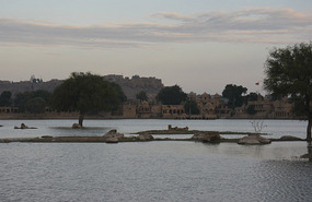 Lake and sunrise view of the fort in the distance