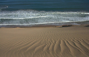 Dunes dropping down from a great height to waves