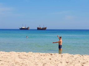 Tourist pirate ships on our beach