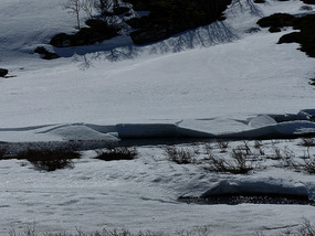 Stream feeding frozen lake