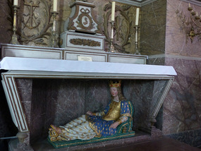 What is this saint doing?