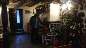 Dinko adding more coal to the stove