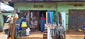 Mrs. Aghimien in front of her shop