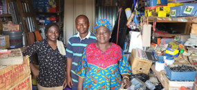Faustina, Osas and Mrs. Aghimien inside the shop