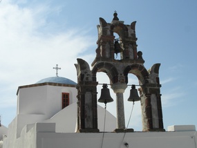 Bells & church dome in walled village.